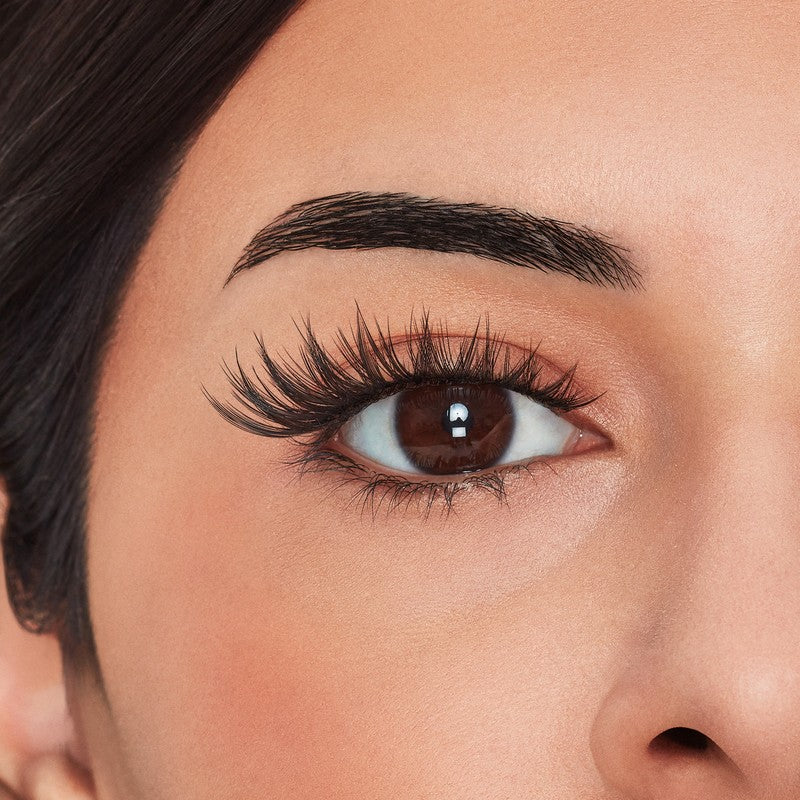 Close-up of a person's eye with long, thick eyelashes