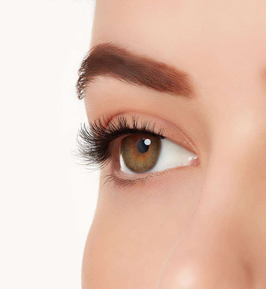 An extreme close-up side shot of a model's eye wearing Ardell's Ecolashes 455 creating A natural, round flared eyelash look