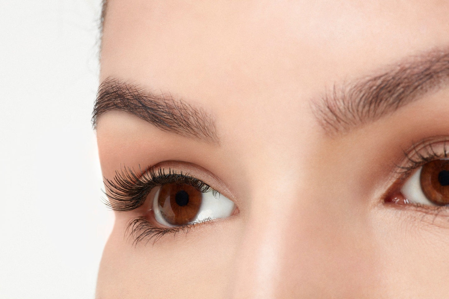 A model with an open right eye wearing Ardell Natural 110 showing how it looks like on an angled view