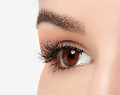 A model with an open right eye wearing Ardell Natural 120 showing how it looks like when worn in a side view